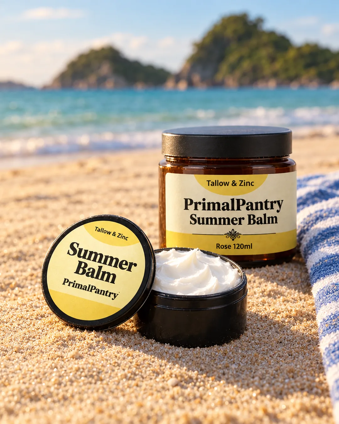 Tallow Summer Balm jar and travel tin on the sand